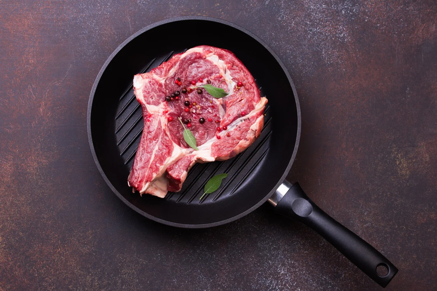 Image of a Beef Ribeye Bone-in on a cast iron skillet